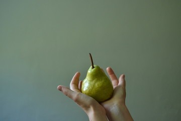 Pear. Pear in the hand. Organic sweet big pear in the white background. 