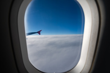 Fototapeta na wymiar The window of the airplane. A view of porthole window on board an airbus for your travel concept or passenger air transportation
