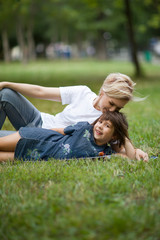 Mother and little daughter playing  laughing together summer outdoors