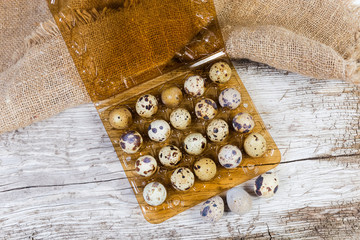 Top view of quail eggs on old wooden surface
