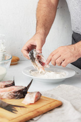Man prepares carp river fish. Cooking healthy and diet food