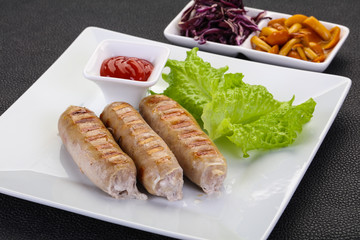 Grilled sausages served mushrooms and cabbage