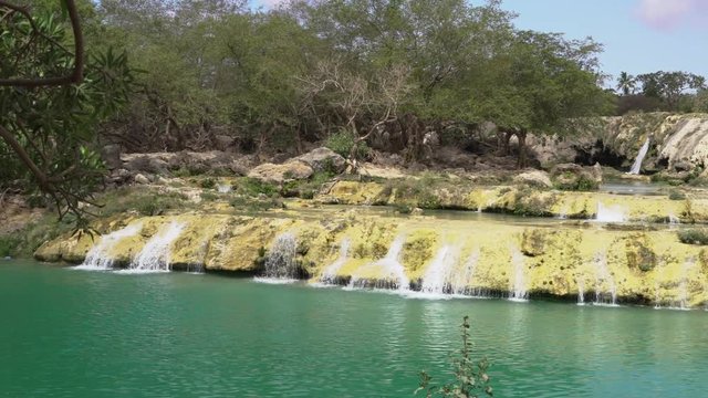 Pan of the Blue water waterfalls up in the mountains of Salalah, Oman in May.