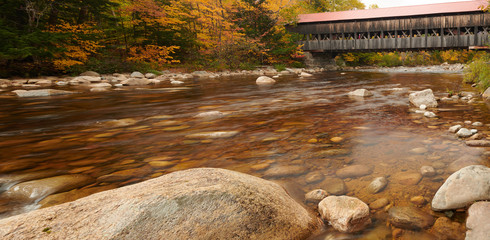 Swift River and old covered Albany Bridge at autumn in White Mountain National Forest, New...