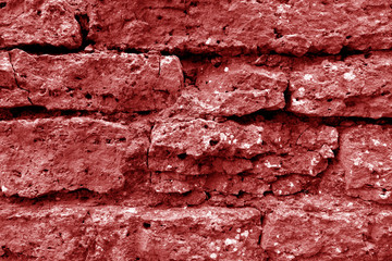 Old grungy brick wall texture in red tone.