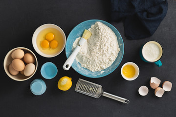 Bakery background. Baking ingredients for cooking homemade muffins or lemon cookies top view
