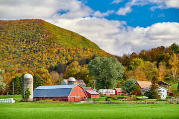 Farm with red barn and silos at sunny autumn day in West Arlington, Vermont, USA