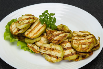 Grilled eggplant slices served basil
