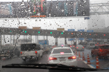 Front view of Driving with car windshield wipers in raining day on the expressway tollgate