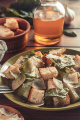 caesar salad and ingredients at wood