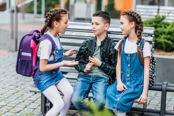 Education, friendship, childhood and people concept - group of happy elementary school students...