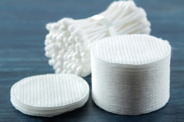 Cosmetic cotton pads. A stack of cotton pads and cotton buds on a blue wooden background. spa. close-up.