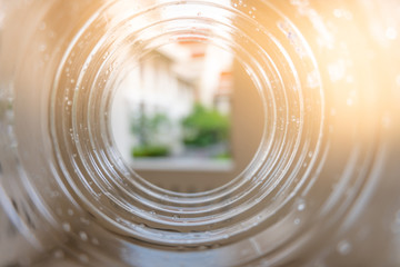 The building through a plastic bottle with a blurred bottle on blurred natrue background....