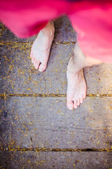 Forest adventure: Closeup of barefoot male feet on a wooden bridge in the woodland