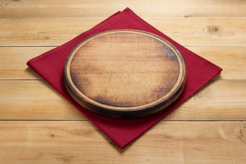 pizza cutting board at rustic wooden table in front