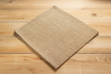 burlap hessian sacking cloth on wooden background