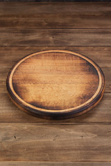 pizza cutting board at rustic wooden table in front