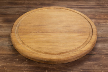 pizza cutting board at rustic wooden table in front