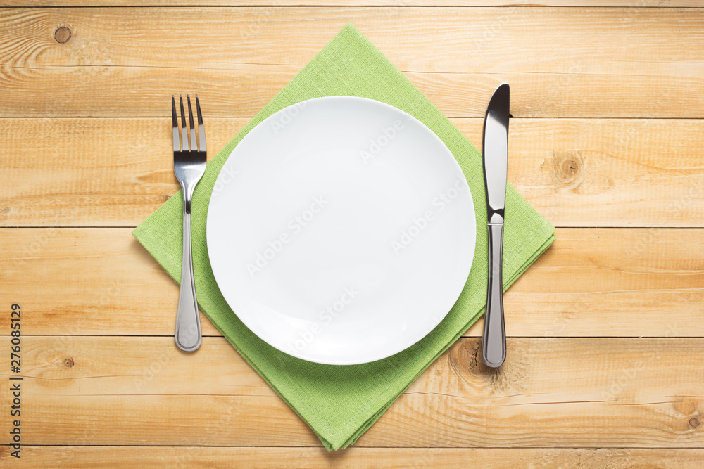 Poster plate, knife and fork at wooden  background