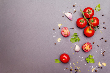Cooking stone concrete background with spices, herbs, tomatoes
