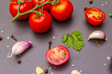 Cooking stone concrete background with spices, herbs, tomatoes