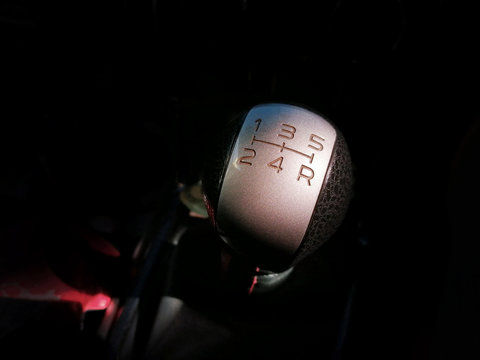 Gear stick of manual transmission of car with 5-speed and reverse position, automotive part concept.