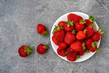 Strawberry in a plate on stone background