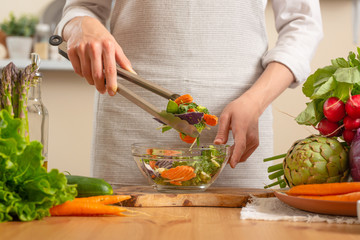 The chef prepares a fresh and bright salad close-up,on a light background. The concept of losing healthy and healthy food, detox, vegetarian food, diet, cooking Slow food, comfort food,healthy diet