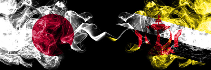 Obraz premium Japan vs Brunei, Bruneian smoky mystic flags placed side by side. Thick colored silky smokes combination of Brunei, Bruneian and Japanese flag