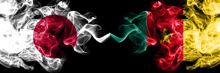 Japan vs Cameroon, Cameroonian smoky mystic flags placed side by side. Thick colored silky smokes combination of Cameroon, Cameroonian and Japanese flag