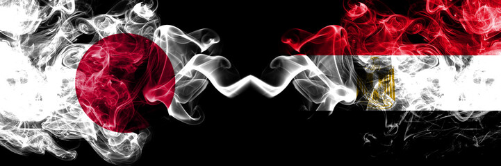 Japan vs Egypt, Egyptian smoky mystic flags placed side by side. Thick colored silky smokes combination of Egypt, Egyptian and Japanese flag