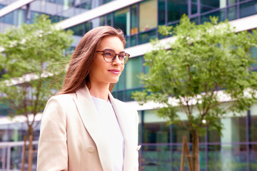 Businesswoman walking on the street between office buildings