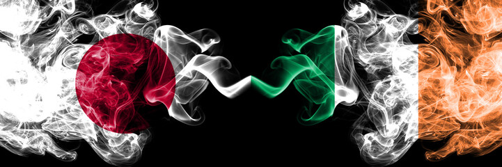 Japan vs Ireland, Irish smoky mystic flags placed side by side. Thick colored silky smokes combination of Ireland, Irish and Japanese flag