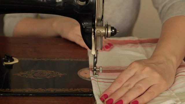 Seamstress sews on a sewing machine