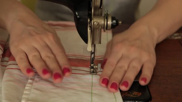 Seamstress sews on a sewing machine