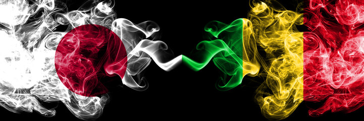 Japan vs Mali smoky mystic flags placed side by side. Thick colored silky smokes combination of Mali and Japanese flag