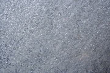 A surface of a architectural stone.(gray, white, purple and sparkling, rough)