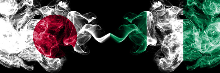 Japan vs Nigeria, Nigerian smoky mystic flags placed side by side. Thick colored silky smokes combination of Nigeria, Nigerian and Japanese flag