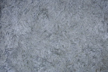 A surface of a architectural stone.(white, gray and amber. rough)
