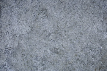 A surface of a architectural stone.(white, gray and amber. rough)