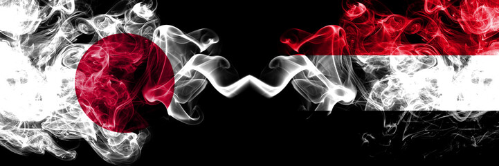 Japan vs Yemen, Yemeni smoky mystic flags placed side by side. Thick colored silky smokes combination of Yemen, Yemeni and Japanese flag