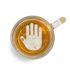 Sign stop gesture on the beer foam in glass isolated on white background. Top view