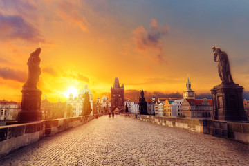 Charles Bridge Karluv Most and Old Town Tower at amazing sunrise with sky and clouds in Prague,...