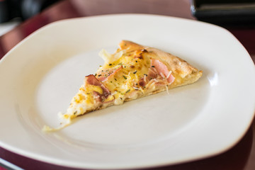 A slice of fresh pizza on a plate.