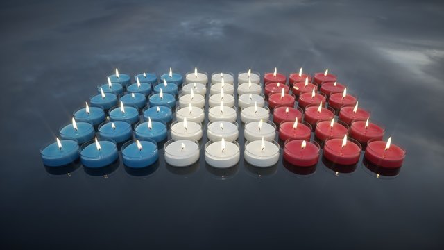 Candles with the colors of the French flag. In memory of the victims.