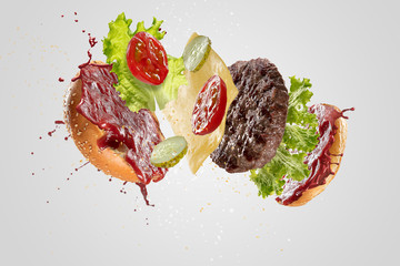 Burger's crashing isolated on white background. Tasty and delicious combination of buns, tomatos,...