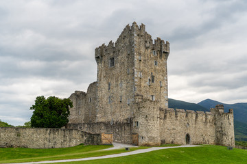 The iconic Ross Castle, stronghold from the Middle Ages, on a cloudy summer day in Killarney, Ireland.