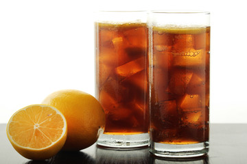 Glasses with cuba libre cocktail or cola with ice or cold tea with lemon