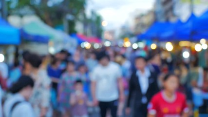 crowd of people walking on city street at night