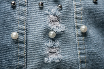 A piece of denim vest decorated with pearl beads and metal balls